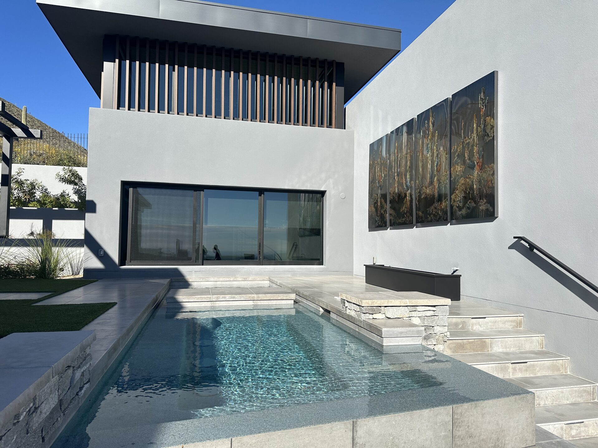 Luxury Scottsdale home with tinted windows at sunset